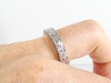 a woman ' s hand holding a ring with a diamond on it