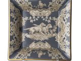 an image of a blue and gold plate with a dog on it
