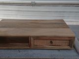 a wooden table with two drawers on top of it