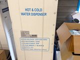 a box of hot and cold water dispenser in a store