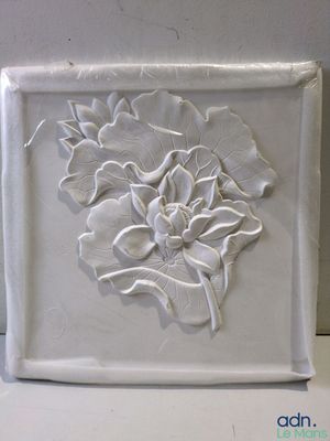 a white plate with a flower on it on a table