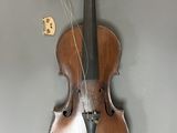 a violin hanging on the wall with a string attached to it