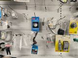 a wall with many different items on it in a store
