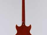 a red guitar hanging from the ceiling with a white background