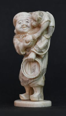 figurine chinoise en ivoire sculpté représentant une femme portant un enfant