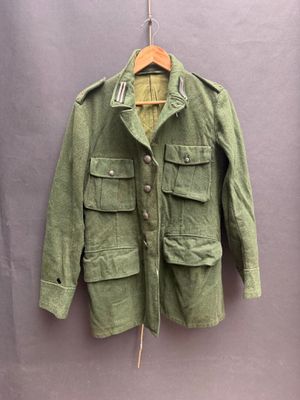 an image of a green jacket hanging on a hanger