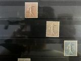 a picture of a man taking a picture of a collection of stamps