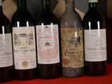 several bottles of wine are lined up on a table
