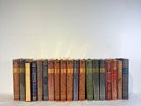 a lot of books that are stacked on top of each other
