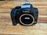 a canon camera sitting on a wooden table