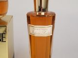 a bottle of perfume sitting next to a box of perfume