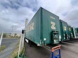a large green truck that is parked in a parking lot