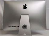 a silver apple computer sitting on a white table