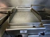 a large grill with a lot of food cooking on it