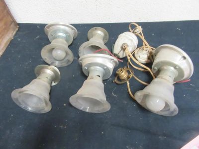 five light bulbs sitting on the floor next to each other