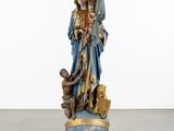 a statue of a woman holding a child in her arms