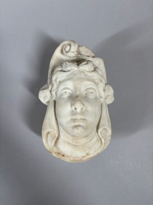 an image of a statue of a woman with a bird on her head