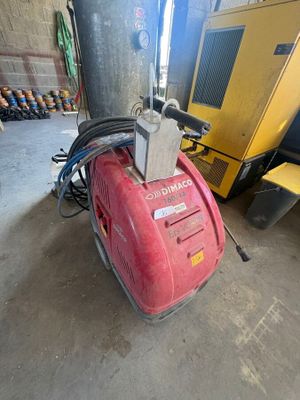 a red machine that is sitting in a garage