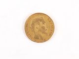 a gold coin with a woman ' s face on it