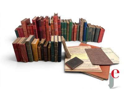 a lot of books that are stacked together on top of each other
