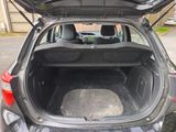 the back of a car with its trunk open on the side of the road