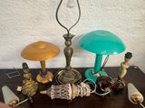 a table with a lamp, a lamp shade, and other items on it