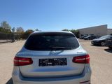 the rear end of a white bmw suv parked in a parking lot