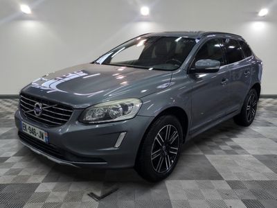 the grey volvo suv is parked on a checkered floor