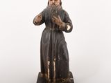 an old statue of a man with a beard and a long beard
