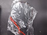 a plastic bag with a helmet on it sitting on a black surface
