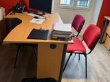 a desk with two chairs and a computer on top of it