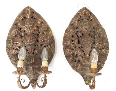 pair of antique wall sconces with ornate carvings and candle holders