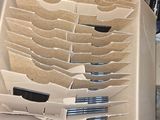 a cardboard box that has a bunch of pens in it
