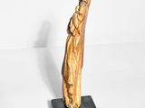 statue of a woman holding a bird on a black base