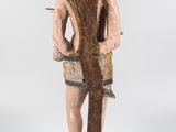 wooden statue of a man with an elephant on his back