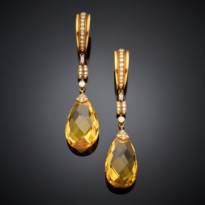 a pair of yellow sapphire and diamond earrings