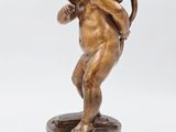 an antique bronze statue of an angel holding a book on a wooden base