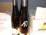 two bottles of wine sitting on a counter next to a box of wine