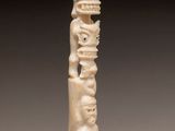 a carved ivory figurine of a man and woman