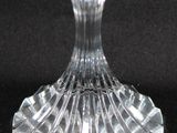 a clear glass vase with a small flower on it