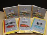 four books of various types of toy cars sitting on a table