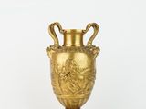 an antique gold vase with handles and handles on a stand