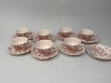 six cups and saucers with pink flowers on them on a table