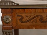 a wooden desk with a decorative design on the top
