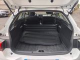 a trunk of a white car with its doors open