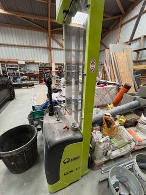 un chariot élévateur dans un entrepôt rempli de bric-à-brac