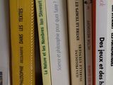 a lot of books that are on a shelf together