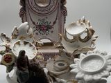 several figurines and a clock are sitting on a table