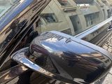 a reflection of a building in the side mirror of a car