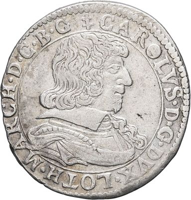 a silver coin with an image of a man on it
